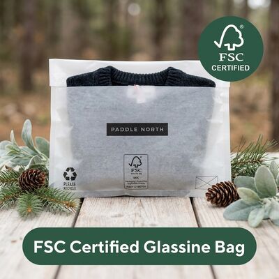 Borsa di carta di vetro di lusso riciclabile senza plastica sul marciapiede con confezionamento di abbigliamento ecologico Borsa di abbigliamento per grasso certificato